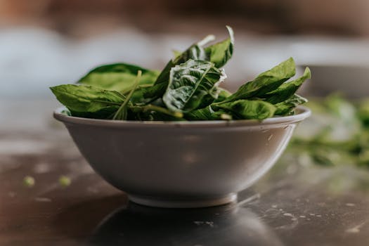pexels-photo-1751149-1751149 Close-up of fresh spinach leaves in a ceramic bowl, perfect for healthy eating themes.