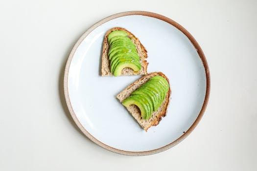 pexels-photo-3872371-3872371 Sliced avocado on whole grain toast presented on a simple plate for a healthy breakfast.