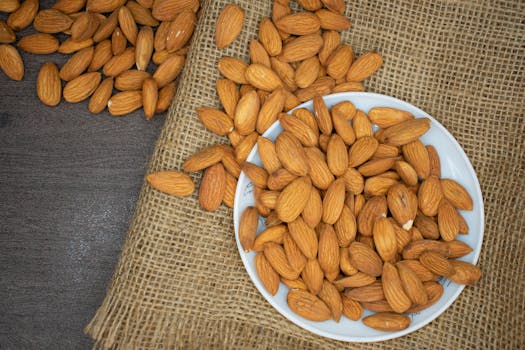 pexels-photo-3997459-3997459 Top view of almonds in a white bowl on a burlap surface, highlighting healthy snacking.