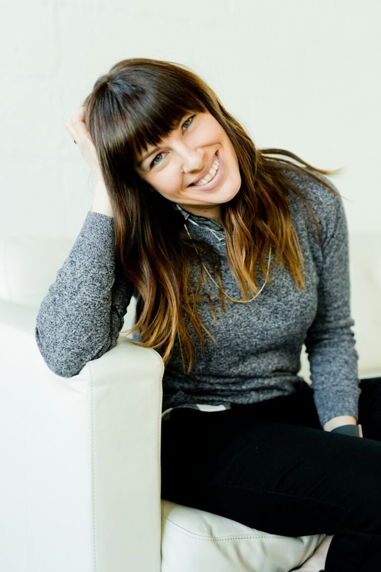 Relaxed woman sitting comfortably on a white couch